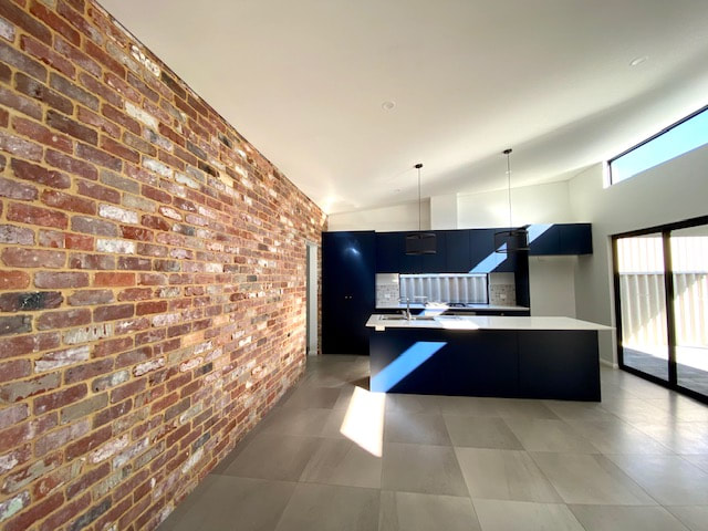 Feature brick wall in open plan living area Spearwood New Built Distinct Renovations 